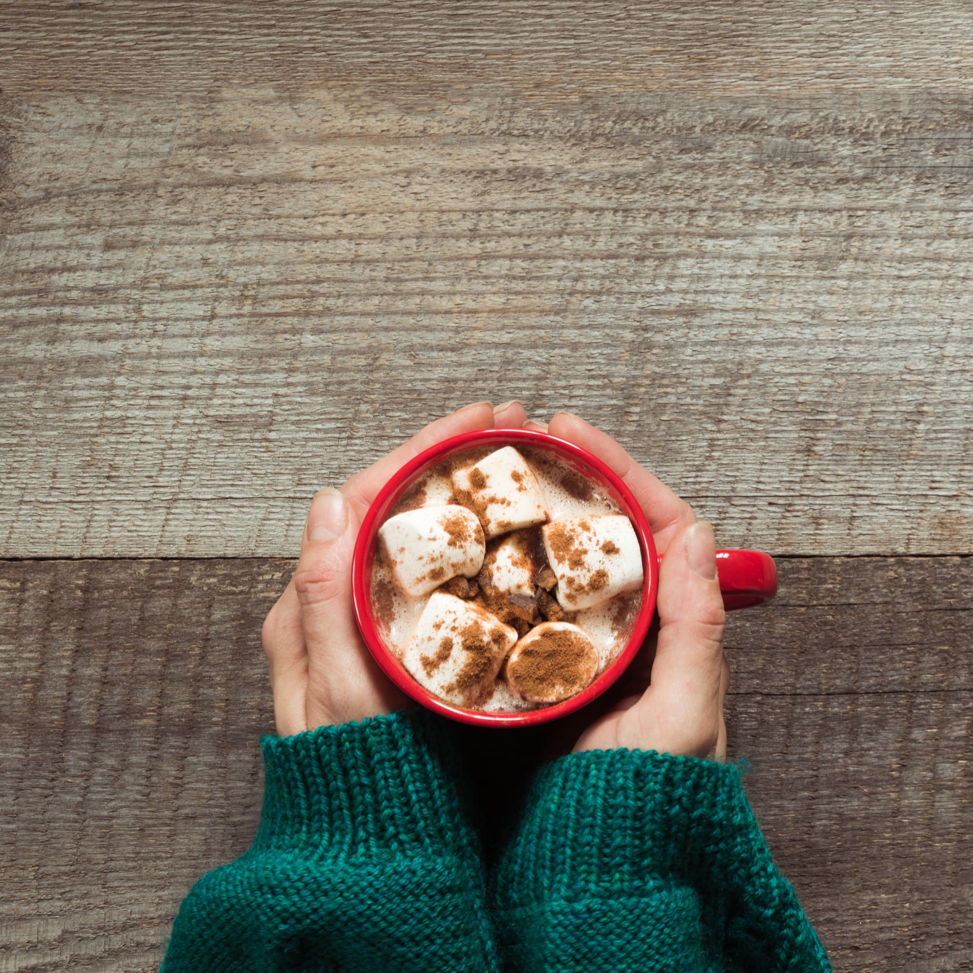 Christmas hot chocolate with marshmallows in hand
